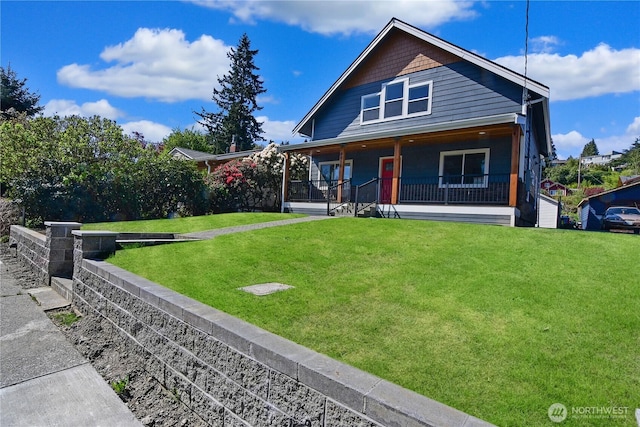 view of front of house with a front yard and covered porch