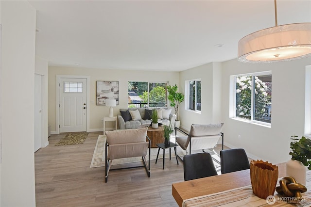 living area with light wood-style floors and baseboards