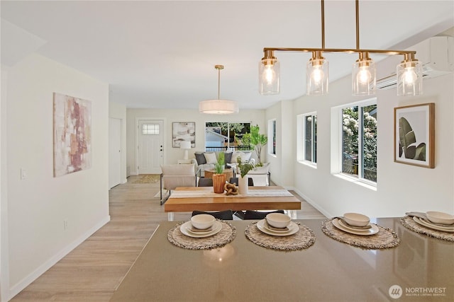 dining area with light wood finished floors and baseboards