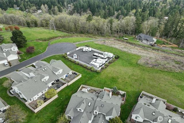 drone / aerial view with a residential view and a view of trees