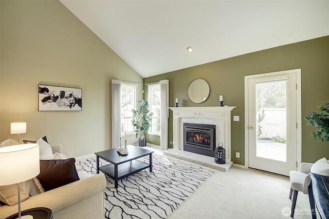 living room featuring a fireplace, carpet, plenty of natural light, and lofted ceiling