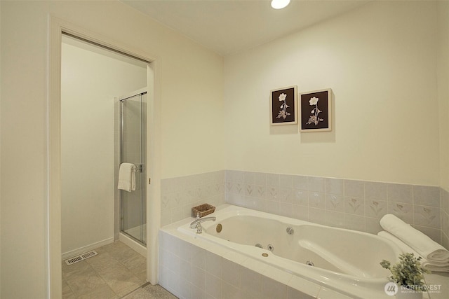 bathroom featuring a shower stall, baseboards, a whirlpool tub, and visible vents