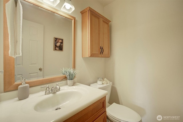 half bathroom with toilet and vanity