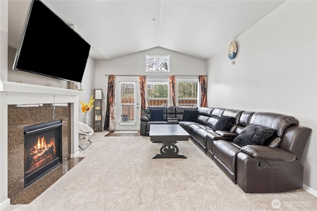 carpeted living area featuring baseboards, high vaulted ceiling, and a fireplace