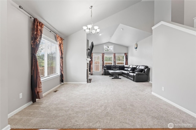 sitting room featuring a chandelier, high vaulted ceiling, carpet, and a wealth of natural light