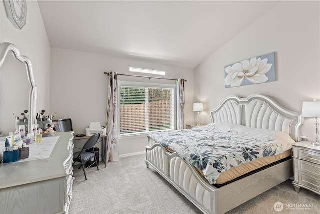 bedroom with light carpet, baseboards, and lofted ceiling