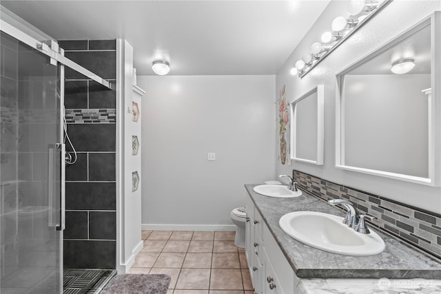 bathroom with double vanity, tile patterned floors, a shower stall, decorative backsplash, and a sink
