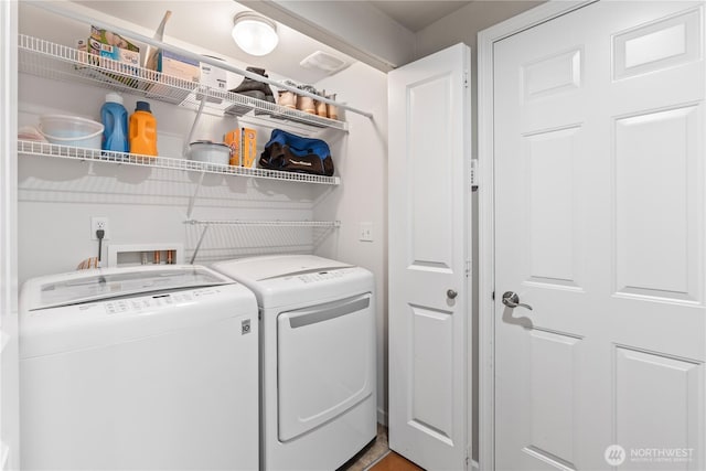 laundry room with washing machine and clothes dryer and laundry area