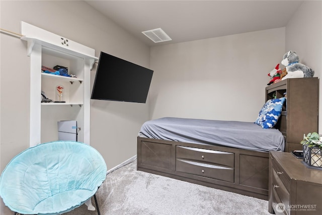 carpeted bedroom featuring visible vents