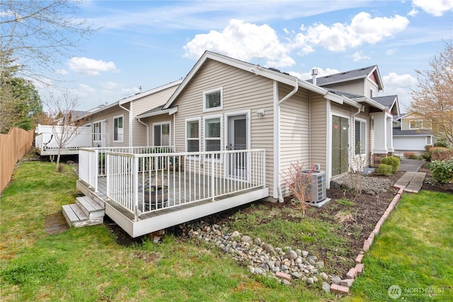 back of house featuring central air condition unit, a yard, fence, and a deck