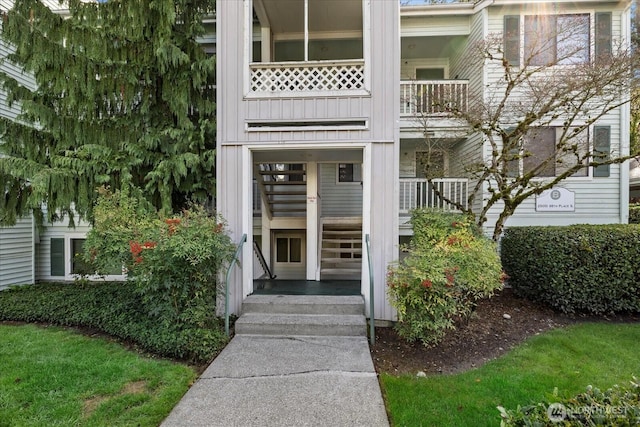 view of exterior entry featuring a balcony