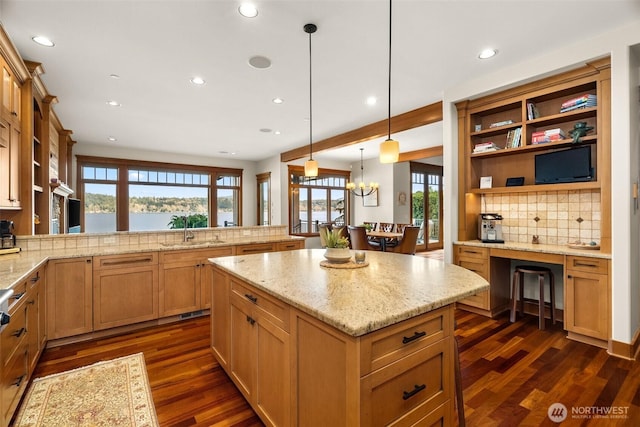 kitchen featuring dark wood-type flooring, a center island, a sink, and open shelves