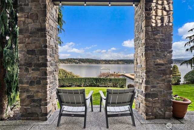 view of patio featuring a water view