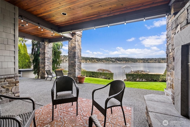 view of patio with a water view