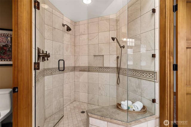 bathroom with a shower stall and toilet