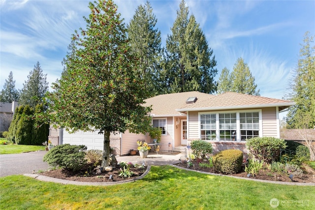 ranch-style home with aphalt driveway, a front yard, and a garage