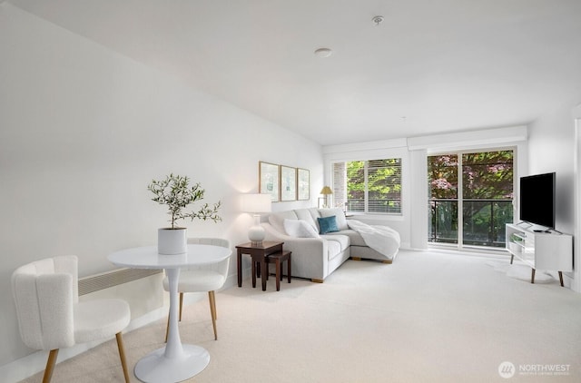 interior space featuring baseboards and light colored carpet