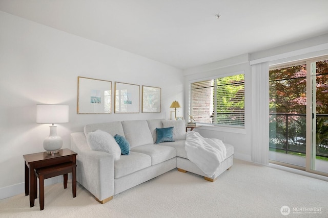 carpeted living room featuring baseboards