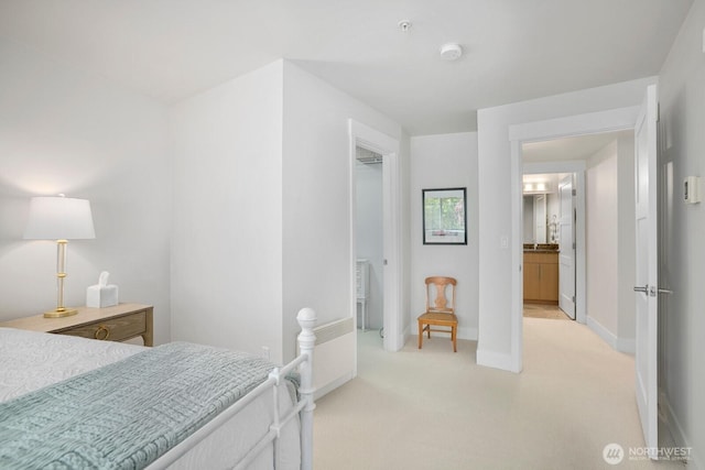 bedroom featuring baseboards and light colored carpet