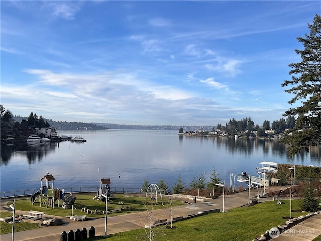 dock area featuring a yard, a water view, and boat lift