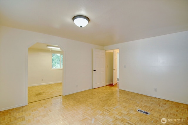 8095 Mosey Ct, Maple Falls, WA 98266 - empty room with arched walkways, baseboards, and visible vents