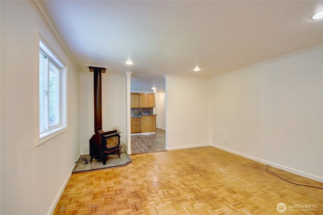 8095 Mosey Ct, Maple Falls, WA 98266 - unfurnished living room featuring ornamental molding, a wood stove, recessed lighting, and baseboards