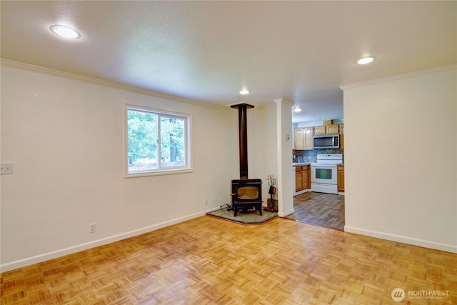 8095 Mosey Ct, Maple Falls, WA 98266 - unfurnished living room featuring recessed lighting, a wood stove, baseboards, and crown molding