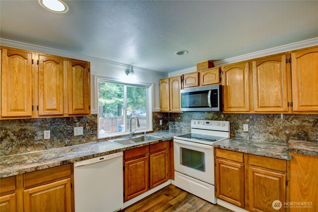 8095 Mosey Ct, Maple Falls, WA 98266 - kitchen with tasteful backsplash, crown molding, a sink, and white appliances