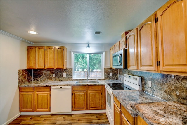 8095 Mosey Ct, Maple Falls, WA 98266 - kitchen featuring tasteful backsplash, ornamental molding, white appliances, a sink, and wood finished floors