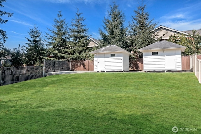 view of yard featuring a fenced backyard, an outdoor structure, and a shed