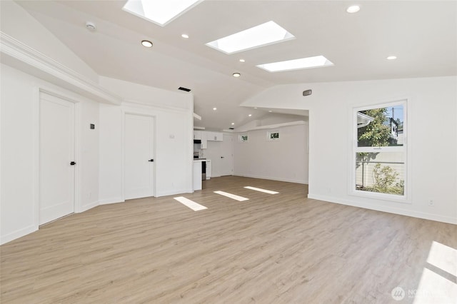 unfurnished living room with recessed lighting, baseboards, light wood-style floors, and lofted ceiling with skylight