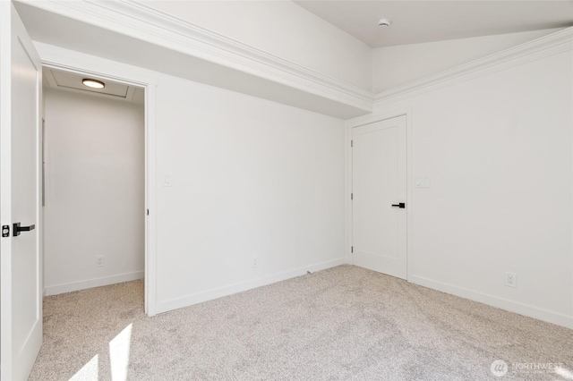 spare room featuring carpet floors and baseboards