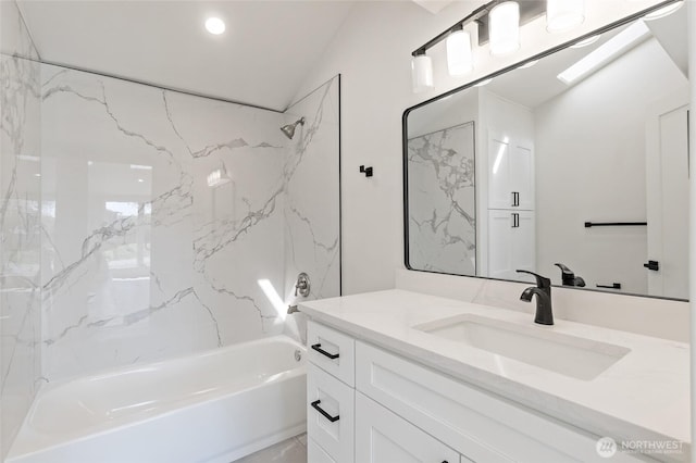 full bath featuring vanity, lofted ceiling, and tub / shower combination