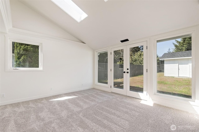 unfurnished sunroom featuring french doors and a skylight
