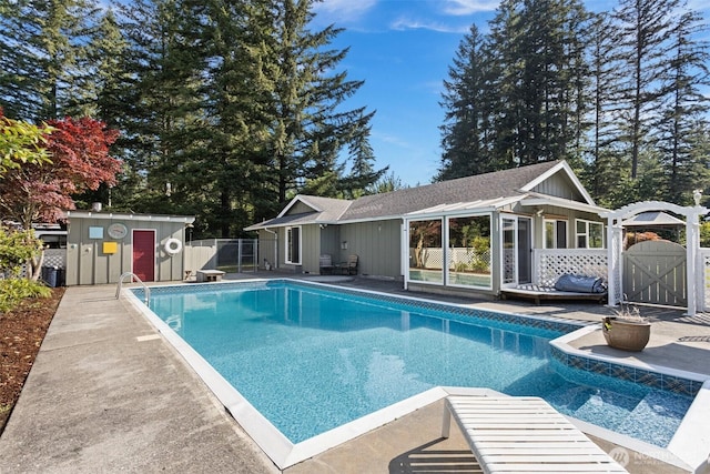 view of swimming pool featuring a patio, a fenced in pool, fence, and a gate