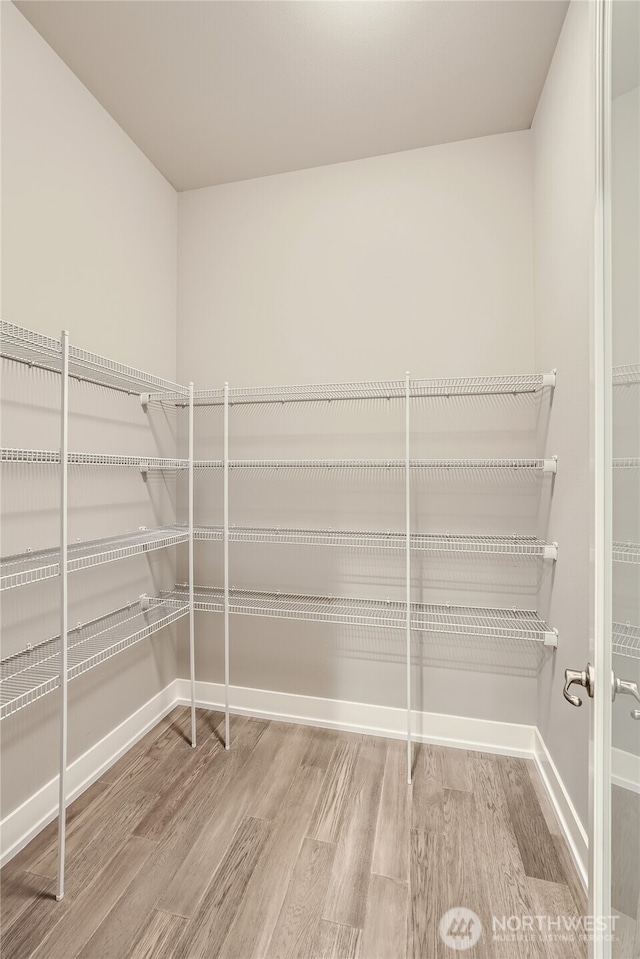 16216 81st Pl NE, Kenmore, WA 98028 - walk in closet featuring wood finished floors