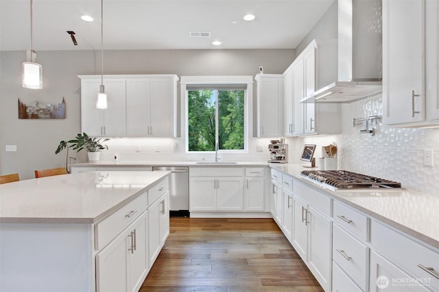 16216 81st Pl NE, Kenmore, WA 98028 - kitchen featuring wall chimney range hood, stainless steel appliances, tasteful backsplash, white cabinetry, and recessed lighting