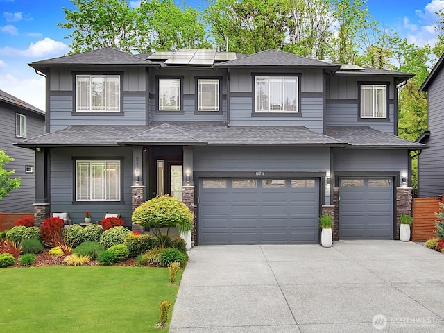 16216 81st Pl NE, Kenmore, WA 98028 - prairie-style house featuring a garage, concrete driveway, a front lawn, and board and batten siding