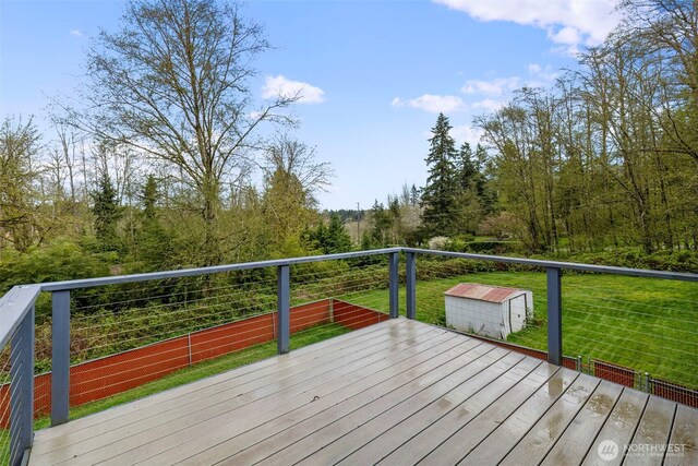 9365 Central Valley Rd NE, Bremerton, WA 98311 - wooden terrace featuring a storage shed, an outdoor structure, and a lawn