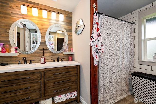 9365 Central Valley Rd NE, Bremerton, WA 98311 - bathroom featuring a sink, double vanity, wood finished floors, and a shower with curtain
