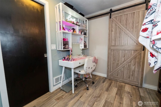 9365 Central Valley Rd NE, Bremerton, WA 98311 - office featuring a barn door, visible vents, baseboards, and wood finished floors