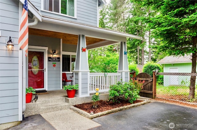 1921 NE Haven Way, Tahuya, WA 98588 - doorway to property with covered porch, fence, and a gate
