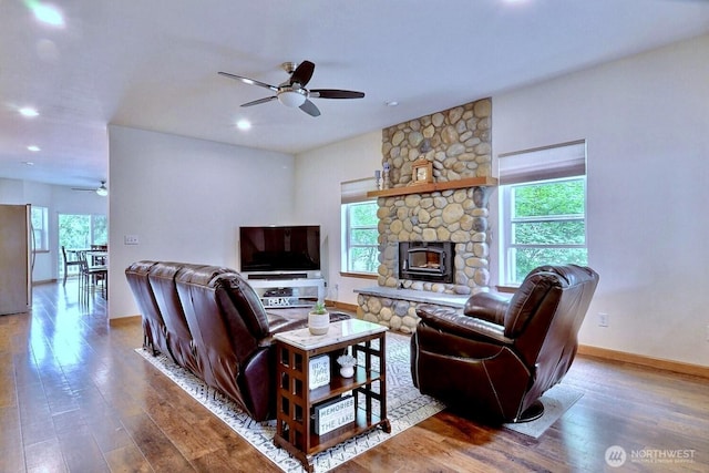 1921 NE Haven Way, Tahuya, WA 98588 - living room with a stone fireplace, ceiling fan, wood finished floors, and baseboards