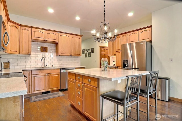 1921 NE Haven Way, Tahuya, WA 98588 - kitchen with a notable chandelier, a kitchen island, dark wood finished floors, stainless steel appliances, and a sink