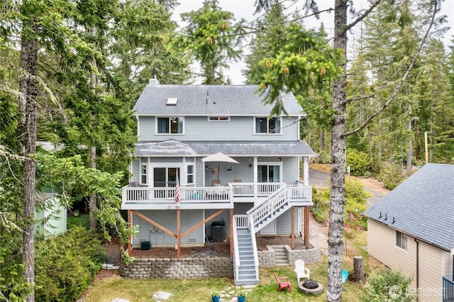 1921 NE Haven Way, Tahuya, WA 98588 - back of property with stairs, a fire pit, a chimney, and a shingled roof