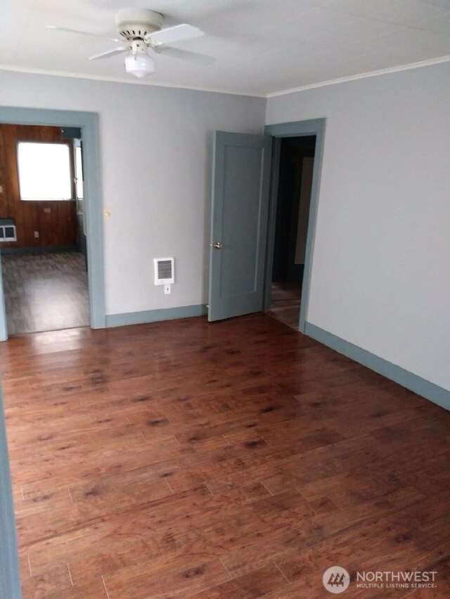 3025 Simpson Ave, Hoquiam, WA 98550 - empty room featuring crown molding, wood finished floors, baseboards, and a ceiling fan