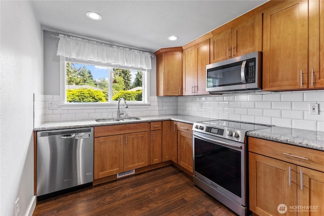 22115 103rd Pl SE, Kent, WA 98031 - kitchen featuring stainless steel appliances, dark wood-style floors, tasteful backsplash, light stone countertops, and brown cabinetry
