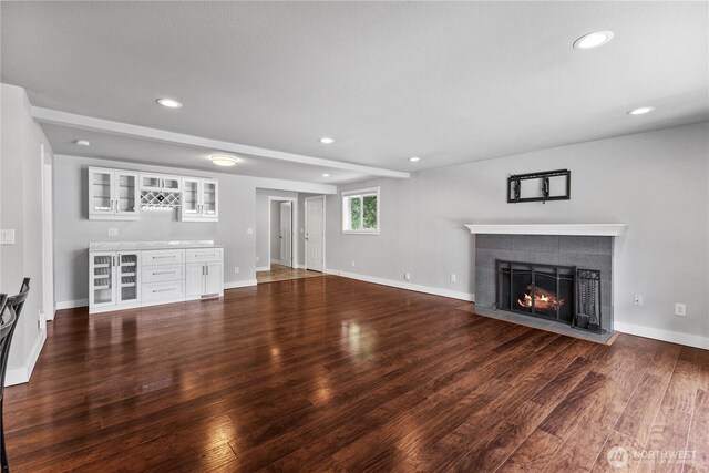 22115 103rd Pl SE, Kent, WA 98031 - unfurnished living room featuring a tiled fireplace, recessed lighting, and dark wood-style flooring