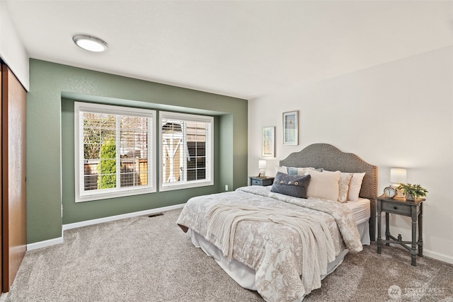 carpeted bedroom featuring baseboards
