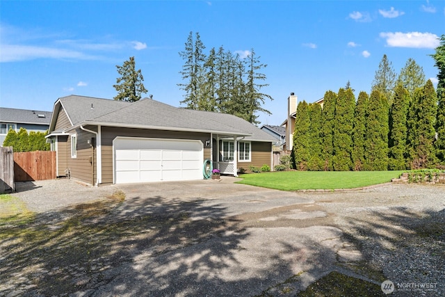 view of front of property with fence, a garage, a front yard, and driveway